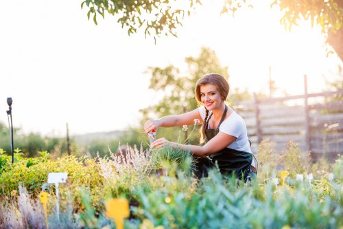 Professional gardener maintaining a beautiful garden in SE22